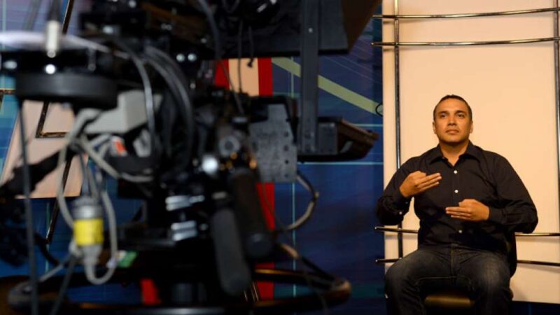 Persona frente a una cámara de tv