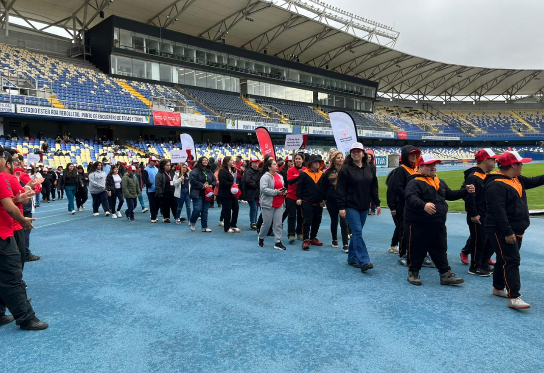 Deportistas con discapacidad desfilando en una pista atlética