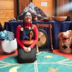 tres personas posando para la foto, una de ellas con vestimenta tradicional de mujer mapuche